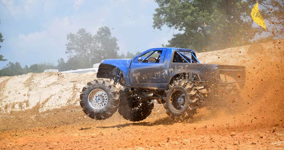 mud truck racing through mud