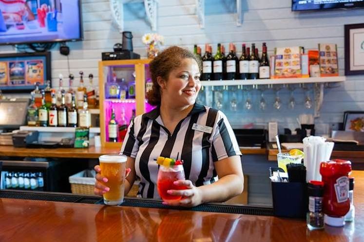 bartender with drinks at Gators Den