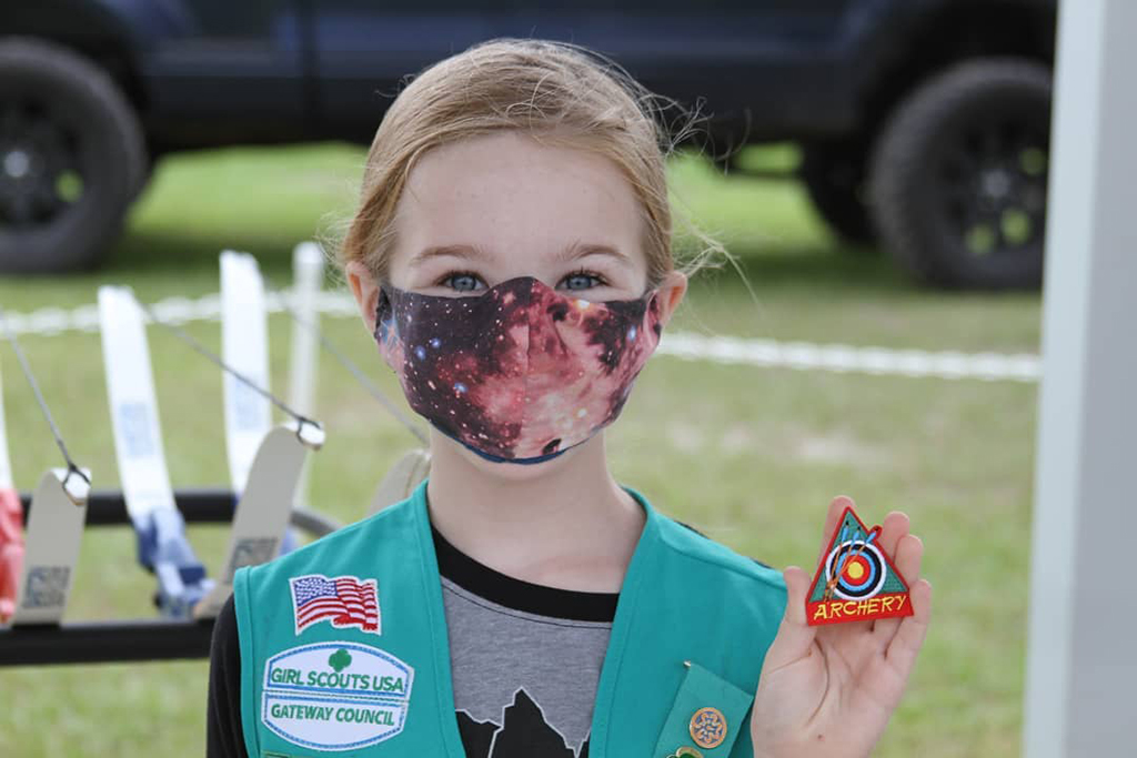 girl scout with archery badge