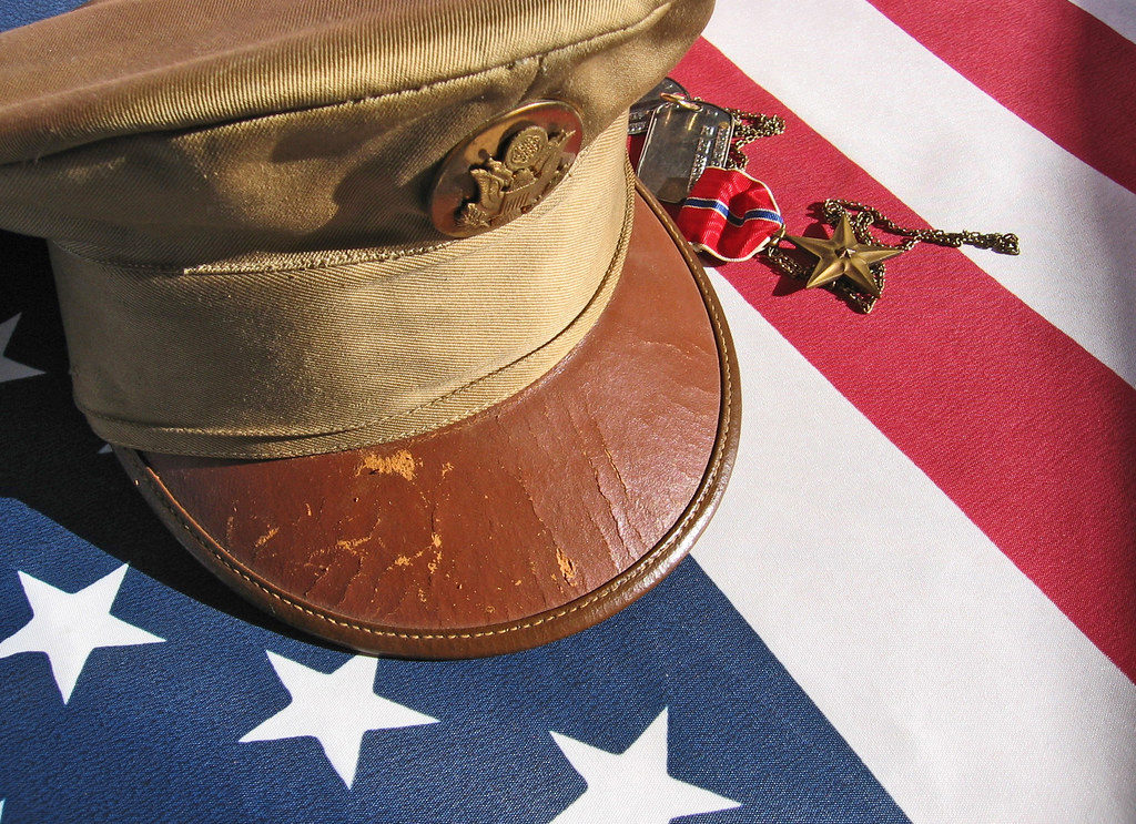 Military hat and medals on American Flag