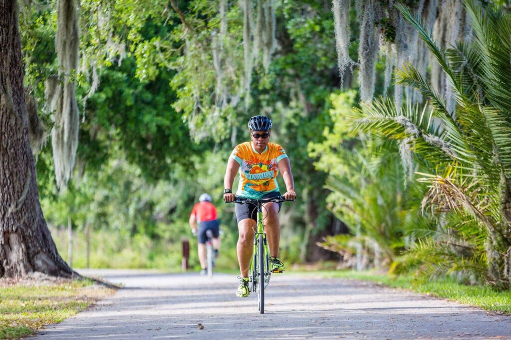 woman riding on Fort Fraiser paved bike trail in Lakeland and Highland City area