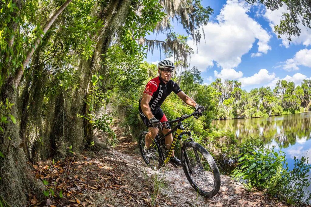 cyclist riding Niner bike at Loyce Harpe Park mountain bike trail system in Mulberry, FL 