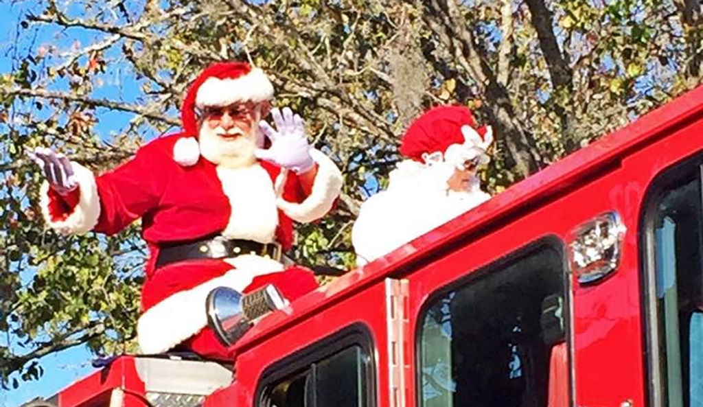 santa and mrs claus on fire truck