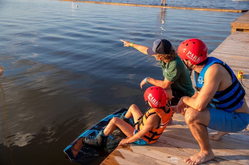 Child getting wakeboard lessons on Lake Myrtle at Elite Cable Park in Auburndale, FL