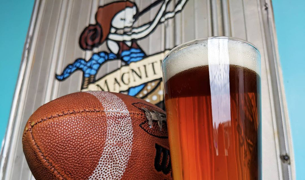 football and pint glass at first magnitude brewing company