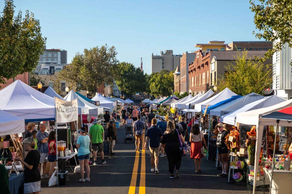 People and vendor tents along Kentucky Ave. in downtown Lakeland during Downtown Farmers Curb Market on Saturday morning.