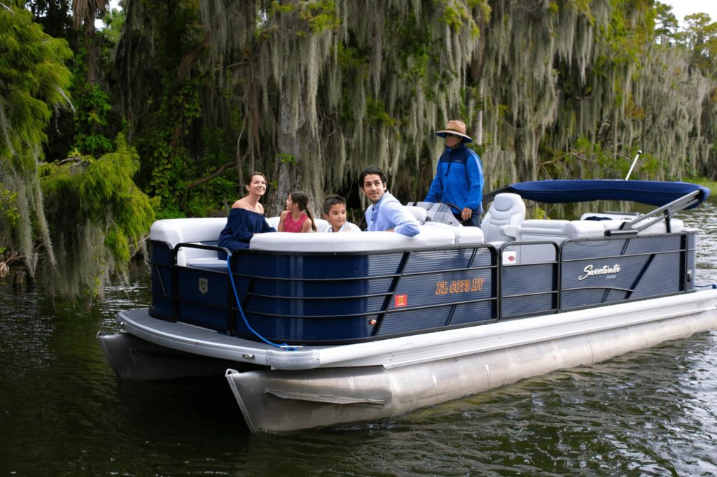 family of four on pontoon boat during tour with The Living Water Boat Cruises in Winter Haven, FL