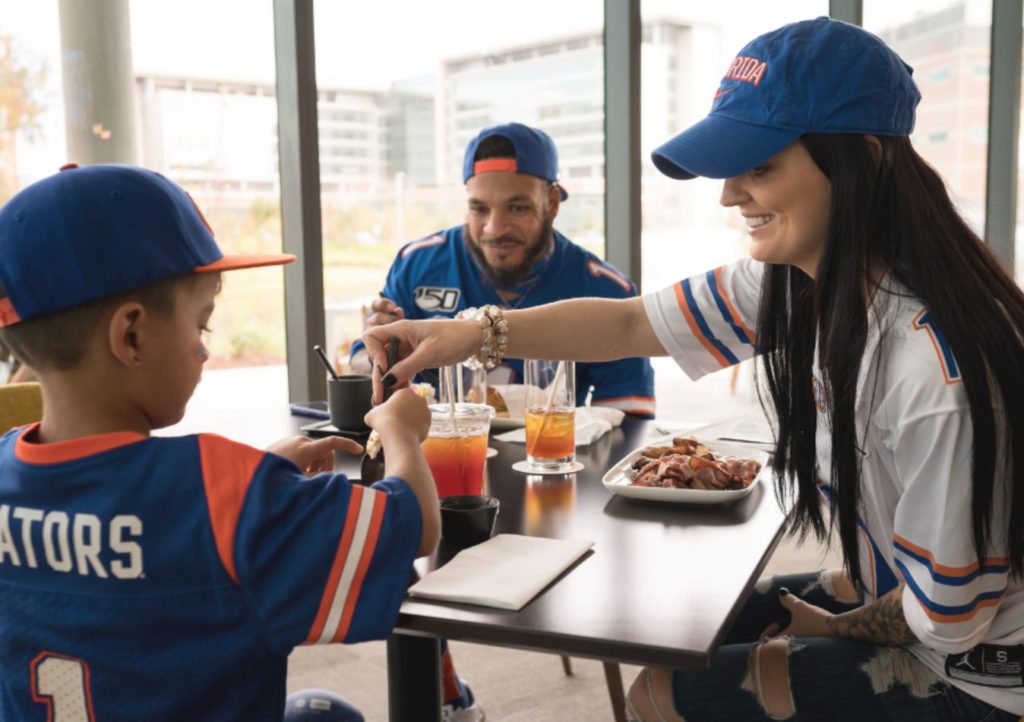 family dining at covey kitchen cocktails wearing florida gators clothing