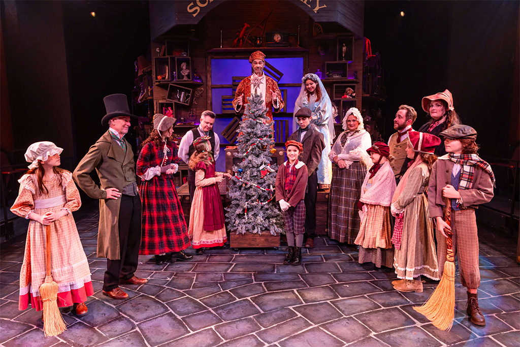 cast on stage of a christmas carol