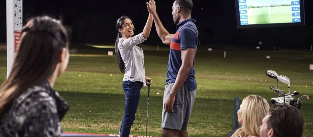 Couple high-fiving during a game at Sailfish Sands Hitting Bays