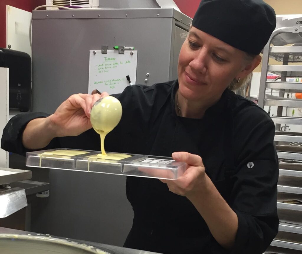 Denise Castronovo pouring chocolate into a mould